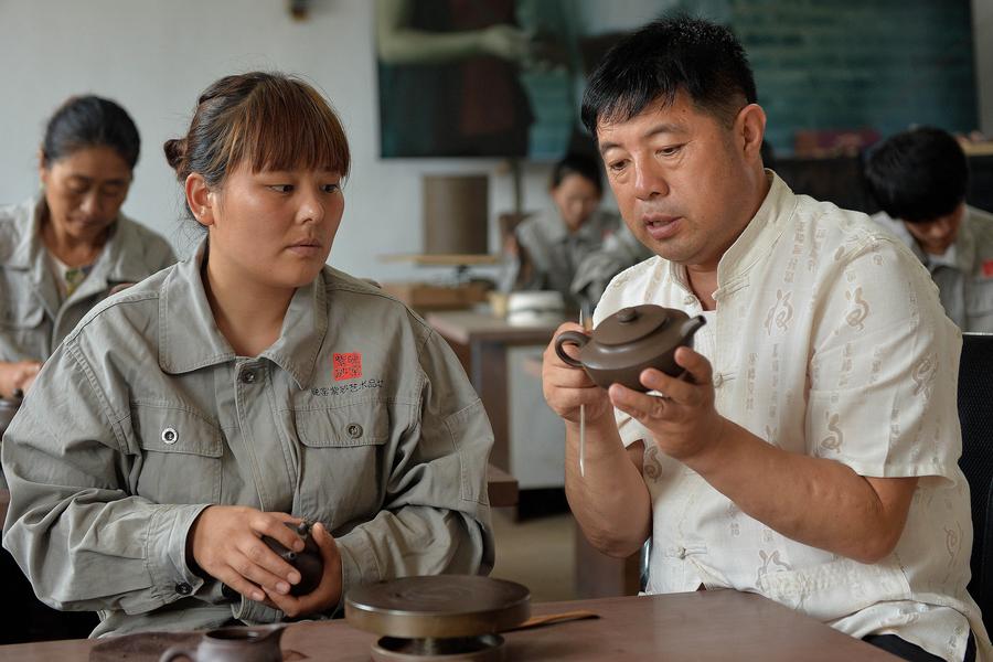 Bai Xuefeng guía a sus artesanos de cerámica en su taller en la ciudad de Chaoyang, provincia de Liaoning , 21 de julio.