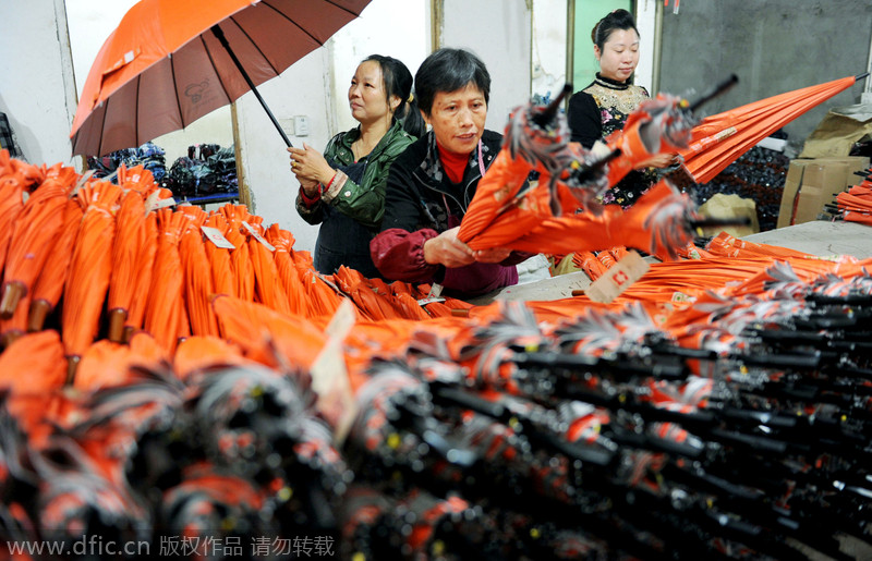 Las trabajadoras comprueban los paraguas en un pueblo de la ciudad de Dexing, en la provincia de Jiangxi, el 29 de noviembre de 2014. [Foto/IC]