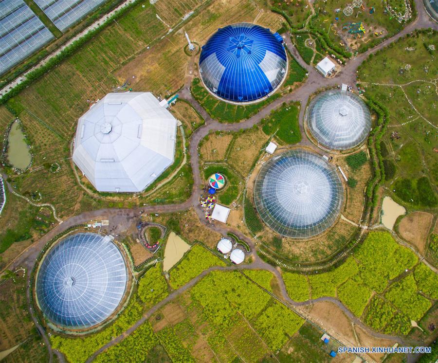  ZHEJIANG, 10 abr (Xinhua) -- Vista aérea de los domos de los invernaderos en el condado de Tiantai, en la provincia de Zhejiang, en el este de China, el 9 de abril de 2016. Nueve invernaderos en forma de domo, con el tema "Espacio Exterior" en el condado de Tiantai, se han convertido en puntos turísticos ya que los visitantes pueden disfrutar el paisaje de primavera y comer de las frutas frescas. (Xinhua/Xu Yu)