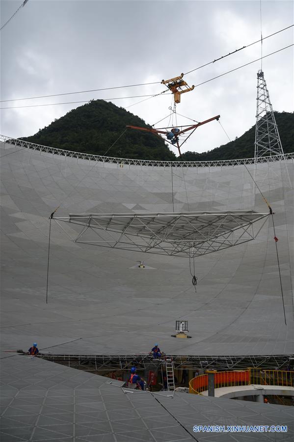 El último panel triangular del reflector del Telescopio de Apertura Esférica de 500 metros, o "FAST", es colocado en el condado de Pingtang, provincia de Guizhou, en el suroeste de China, el 3 de julio de 2016. La instalación del "FAST", el radiotelescopio más grande del mundo, fue completada el domingo por la mañana al colocar el último de los 4,4450 paneles en el centro del gran plato. Los científicos comenzarán las pruebas de depuración y observación del FAST. (Xinhua/Ou Dongqu)