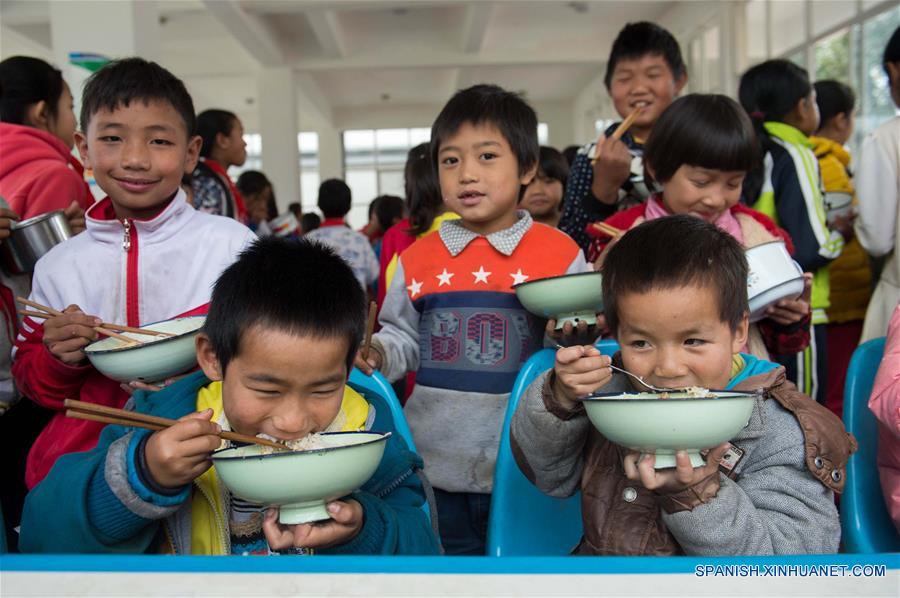 Alumnos de una escuela primaria del poblado Naha del distrito autónomo de la etnia hani de Mojiang de la provincia suroccidental china de Yunnan disfrutan de su almuerzo gratuito. Actualmente, cerca de 27 mil alumnos del distrito comen el almuerzo en escuelas.