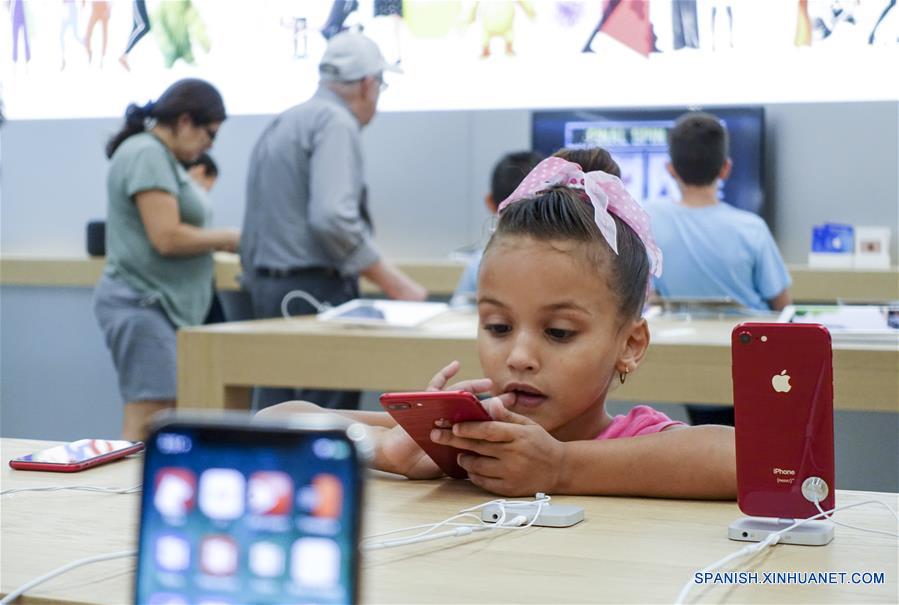 Una niña prueba un producto en una tienda de Apple, en Nueva York, Estados Unidos, el 2 de agosto de 2018. El gigante tecnológico estadounidense, Apple, se convirtió el jueves en la primera compañía cotizada en bolsa en alcanzar el histórico valor de mercado de un billón de dólares. (Xinhua/Wang Ying)