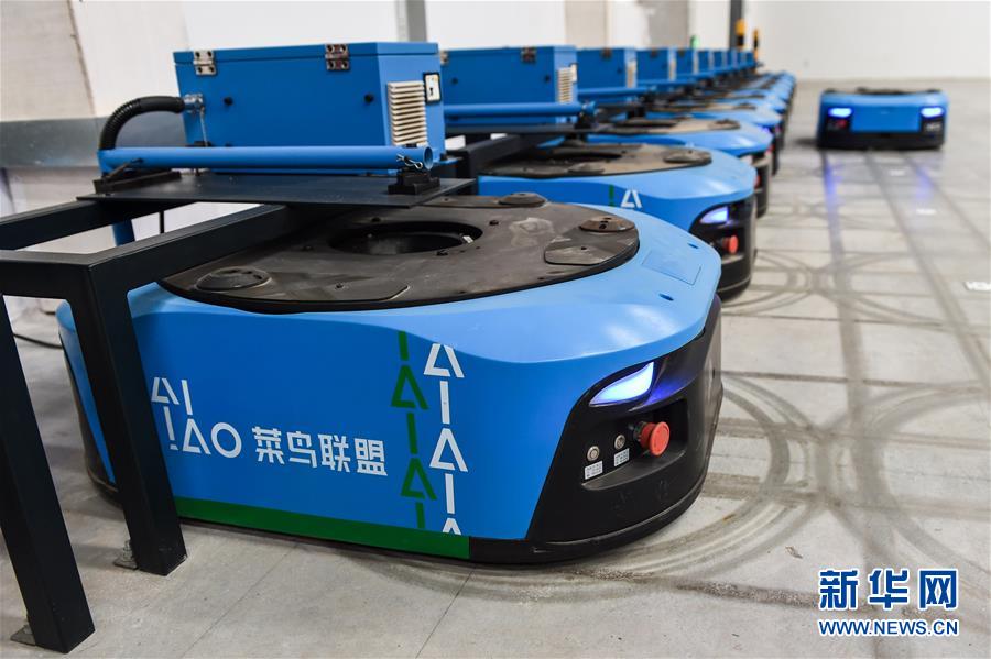 El 8 de noviembre, los robots de manejo inteligente permanecen en la zona de carga donde se cargan automáticamente. Por Li Bo, Agencia de Noticias Xinhua