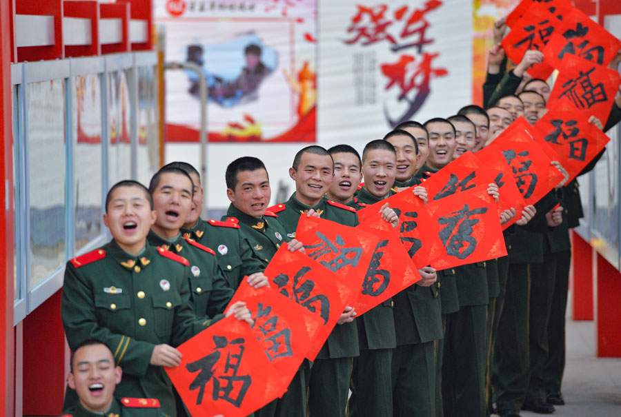 Los soldados muestran su caligrafía con el carácter chino, Fu, que significa buena suerte. [Foto por Hou Chonghui para chinadaily.com.cn]