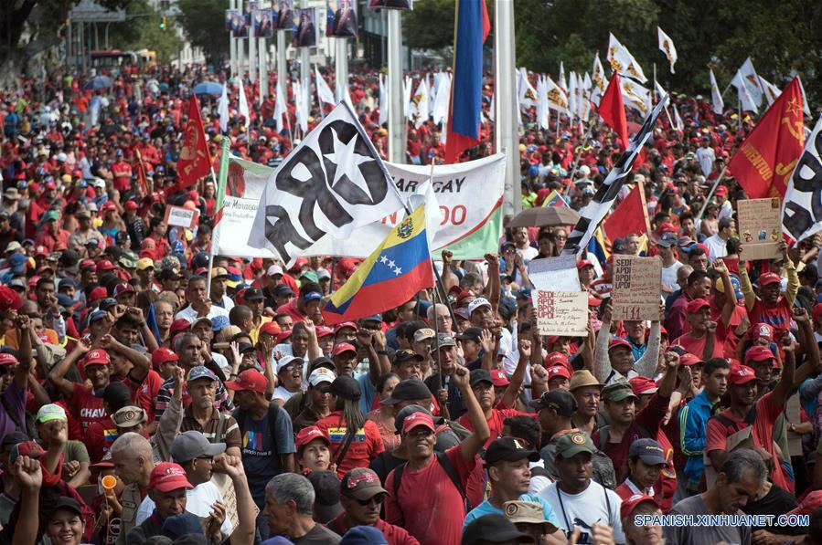 Personas sostienen pancartas durante una marcha en apoyo al presidente de Venezuela, Nicolás Maduro, en Caracas, Venezuela, el 23 de marzo de 2019. El presidente venezolano, Nicolás Maduro, anunció el sábado durante un acto en Caracas la captura de un "poderoso jefe paramilitar colombiano" en el estado de Carabobo (centro-norte). (Xinhua/Marcos Salgado)