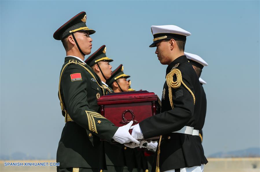 Soldados chinos (i) reciben de manos de soldados sudcoreanos los féretros que contienen los restos de los Voluntarios del Pueblo Chino fallecidos en la Guerra de Corea (1950-1953), durante una ceremonia de transferencia llevada a cabo en el Aeropuerto Internacional de Incheon, en Incheon, República de Corea, el 3 de abril de 2019. Los restos de 10 soldados chinos fallecidos en la Guerra de Corea han sido devueltos a China el miércoles desde la República de Corea. (Xinhua/Wang Jingqiang)