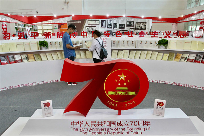 Los visitantes leen en la sección “70 Aniversario de la Fundación de la República Popular China” durante la XVI Exposición Internacional del Libro de Beijing, 21 de agosto del 2019. [Foto: Zhang Wei/ Chinadaily.com.cn]
