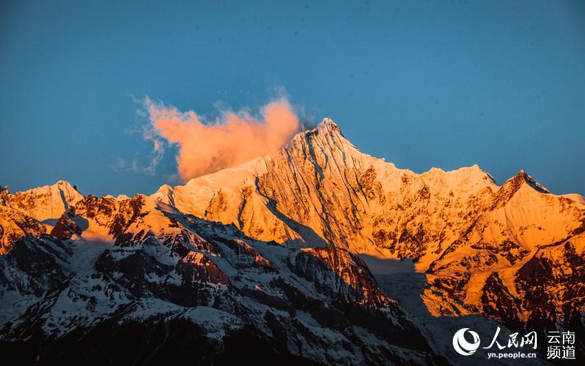 Espectacular resplandor dorado en las montañas nevadas de Meili