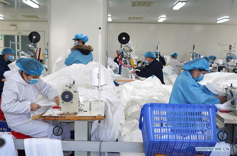NANCHANG, 2 febrero, 2020 (Xinhua) -- Imagen del 1 de febrero de 2020 de trabajadores fabricando trajes protectores en un taller de una compañía en el distrito Jinxian, provincia de Jiangxi, en el este de China. Para ayudar a combatir el brote de neumonía causada por el nuevo coronavirus, los trabajadores de muchas compañías de material médico se apresuraron a trabajar antes de lo previsto. (Xinhua/Wan Xiang)