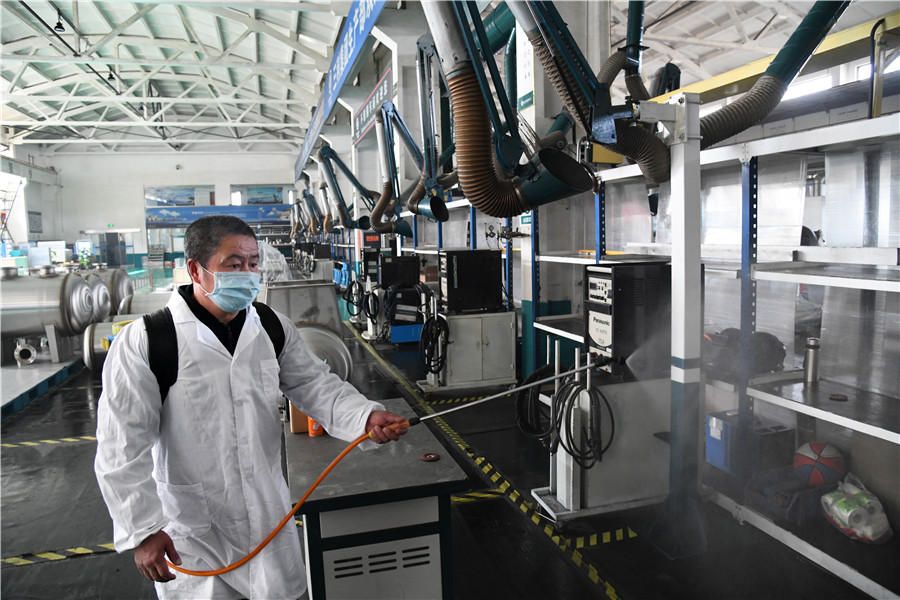 Un empleado de prevención de epidemias rocía desinfectante en un taller para prepararse para reanudar el trabajo en Qingdao, provincia de Shandong, este de China, el 9 de febrero de 2020. [Foto: Xinhua]