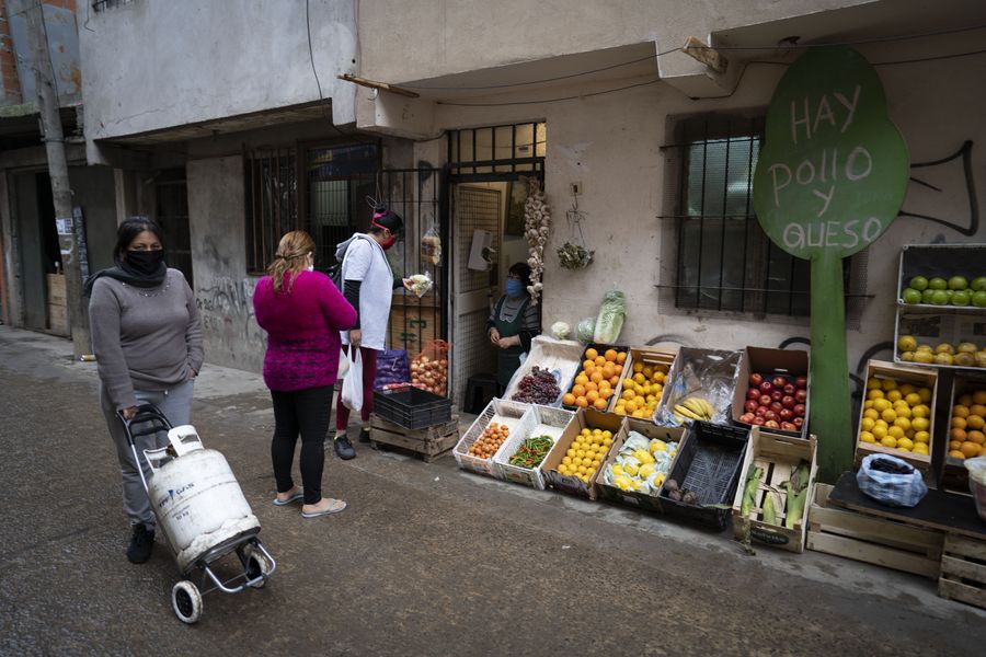 Habitantes realizan compras en un negocio de frutas y verduras en un callejón del barrio Playón Chacarita, en la ciudad de Buenos Aires, capital de Argentina, el 8 de junio de 2020. (Xinhua/Martín Zabala)