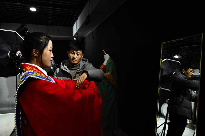 Hu Chunqing organiza los trajes para su exhibición en su estudio. [Foto: Xinhua]