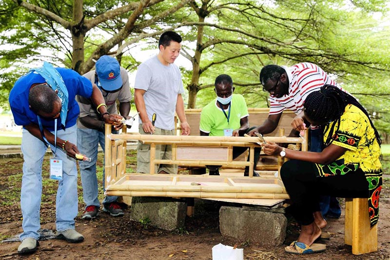 Los jóvenes de Ghana aprenden a hacer mesas de bambú con expertos chinos en arte del bambú. Foto cortesía del Centro Internacional de Bambú y Ratán.