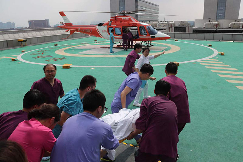 Trabajadores médicos llevan a un paciente gravemente enfermo a un helicóptero en el inundado Hospital Cardiovascular Central de China de Fuwai en Zhengzhou, capital de la provincia central china de Henan, el 22 de julio de 2021. [Foto de Wang Jing / chinadaily.com.cn]