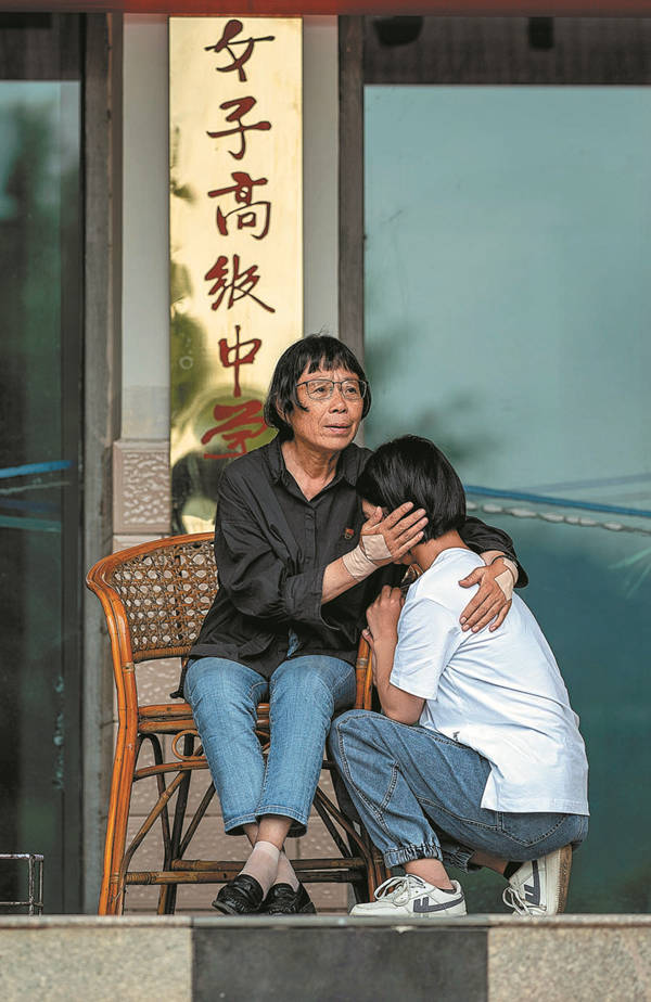 Zhang Guimei (a la izquierda) consuela a Yang Limei. [Foto: Xinhua]