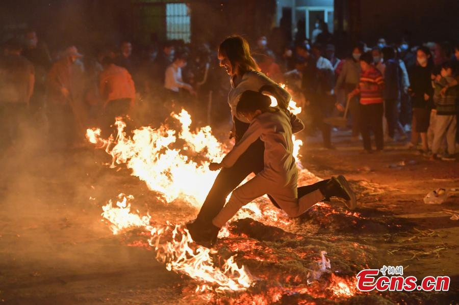 Haikou celebra la costumbre local de 'saltar sobre la hoguera' durante el Festival de los Faroles