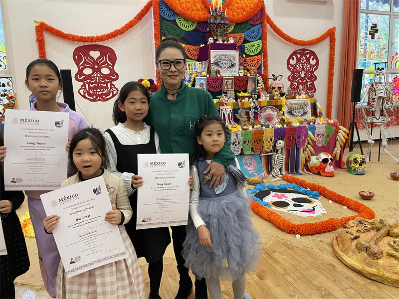 Niños chinos y jóvenes mexicanos decoran en Beijing el altar del Día de Muertos