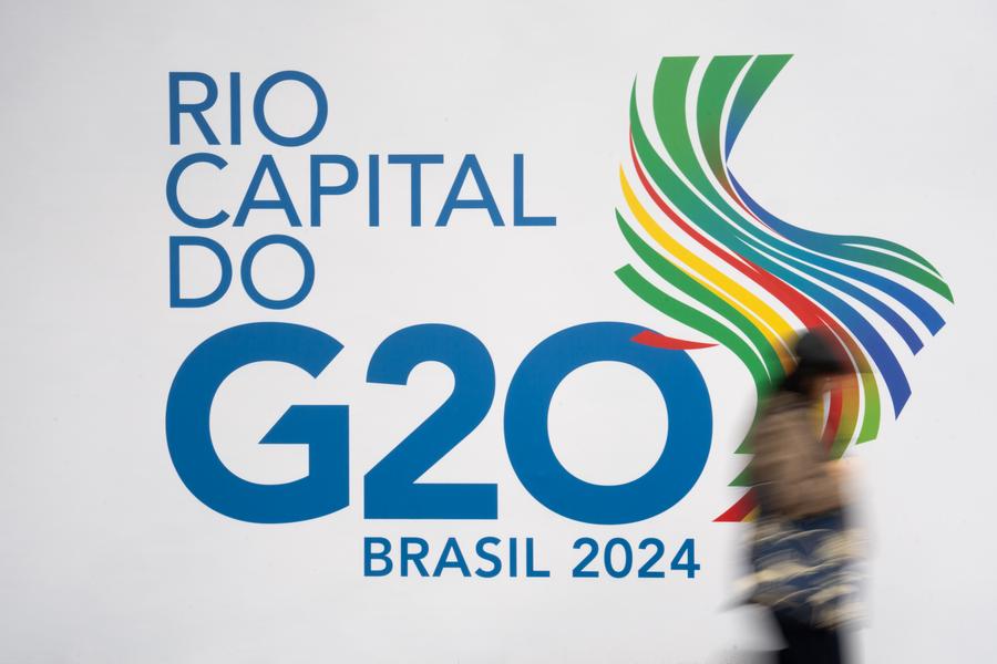 Una mujer camina junto a un logotipo del G20 cerca de la sede principal de la 19ª Cumbre del G20 en Río de Janeiro, Brasil, el 16 de noviembre de 2024. (Xinhua/Wang Tiancong)