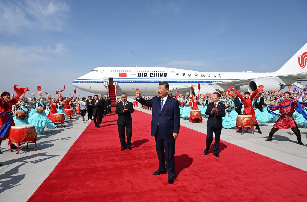 El presidente chino, Xi Jinping, también secretario general del Comité Central del Partido Comunista de China y presidente de la Comisión Militar Central, saluda a una multitud que le aclama a su llegada a Urumqi, en la región autónoma uygur de Xinjiang, en el noroeste de China, el 23 de septiembre de 2025. Xi, encabezando una delegación central, llegó el martes a Urumqi, capital de la región autónoma uygur de Xinjiang, para asistir a las actividades conmemorativas por el 70º aniversario de la fundación de la región. (Xinhua/Xie Huanchi)