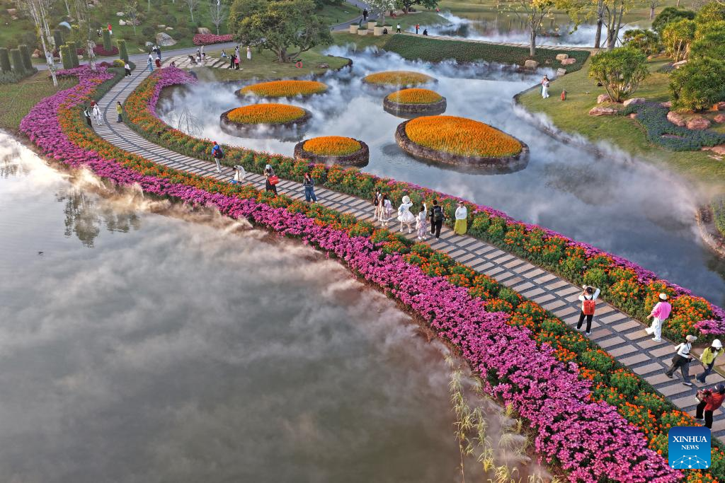 Turistas disfrutan de las flores en montaña Qingxiu de Guangxi